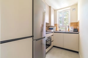 Modern kitchen with a microwave-oven, coffee maker, and toaster. - Spacious Room in Madrid (Madrid)
