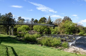 A suspension bridge over a river with surrounding greenery and trees. - The Little River Cottage - by the Meander River Deloraine (Deloraine)