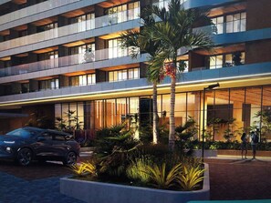 A multi-story hotel with a modern design, featuring balconies, large windows, and a landscaped garden with palm trees. - Beau Studio, with a view of the sea in the iconic Rio Vermelho neighborhood (Salvador)