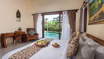 A hotel room with a bed, a desk, and a view of a swimming pool.