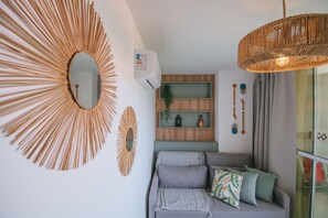 A modern living room with a large mirror, a woven light fixture, and a built-in shelf unit. - Nixxus 316 (Ipojuca)