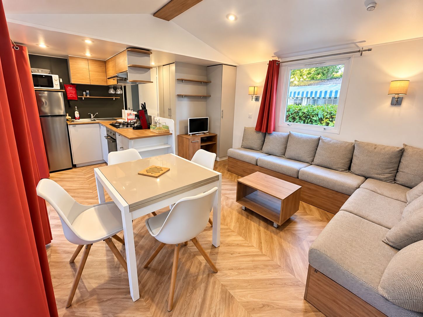 A compact living space with a kitchenette, dining area, and seating area.