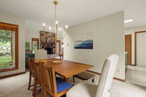 A dining area with a wooden table, chairs, and a chandelier. - "Shanty Springs Retreat" -  Your Creekside Oasis (Banner Elk)