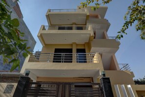 A multi-story residential building with balconies and a gated entrance. - Hotel O AKKI RESIDENCY (Noida)