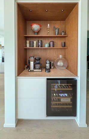 A compact kitchenette with a coffee maker, a kettle, and a glass container on the countertop. - Architect-designed villa with sea views near Tjörn (Stenungsund)
