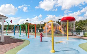 A water park with play structures and a water slide. - 4 Bedroom 3 Bathroom Villas At Seven Dwarfs 14-108 (Kissimmee)