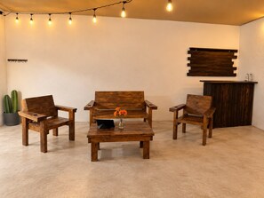 A room with three wooden chairs, a small table, and a potted plant. - New Listing (Monterrey)