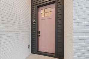 Your entry to a Nashville house designed for 12: a welcoming street-side door that opens onto four separate bedrooms, each with its own bathroom, and a rooftop waiting above - Nashville house with private rooftop patio near Broadway, sleeps 12 (Nashville)