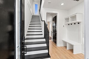 Step through the front door into an open foyer with a bench to drop bags and a staircase leading upward to the action - Rooftop fire pit & game room, sleeps 10 near downtown Nashville & Broadway (Nashville)