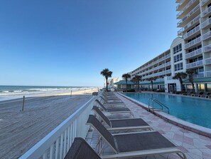 A beachfront hotel with a pool, beach access, and multiple balconies. - Studio Beach Access Studio Kitchen Amazing Location (Daytona Beach)
