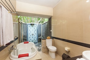 A modern bathroom with a bathtub, toilet, and shower area. - Kadiga Villas - 2 BR pool Villa (Bali)