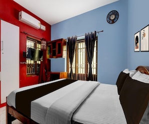 A room with a bed, a television, a window with curtains, and a wall clock. - Classic Balaramapuram White Castle (Neyyattinkara)
