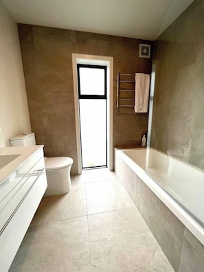 Ground level full bathroom with tub shower combination. 