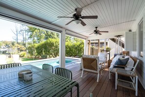 A covered outdoor area with a pool, seating, and ceiling fans. - Newly Renovated Annapolis Escape with Pool, Hot Tub & Sauna (Annapolis)