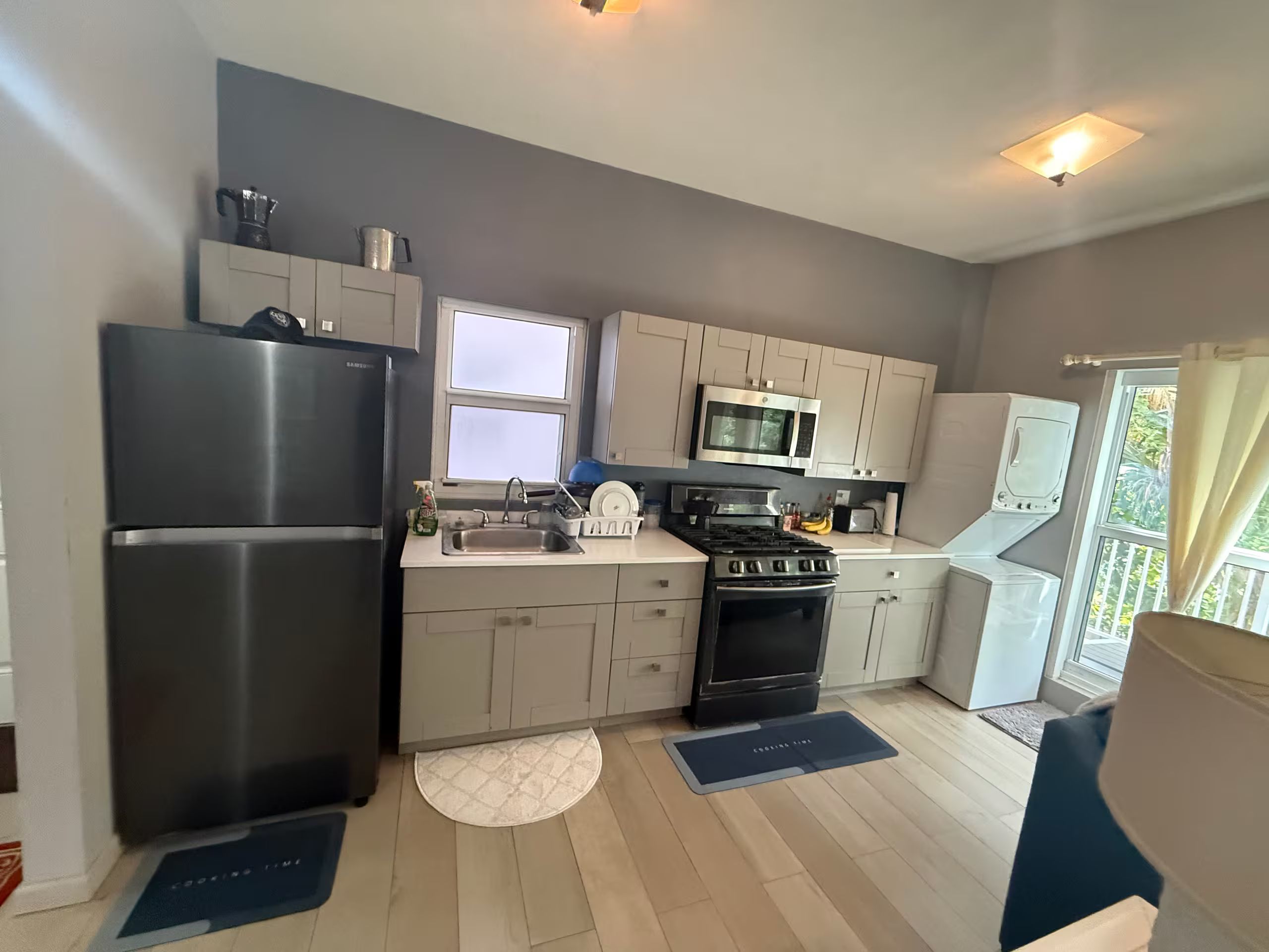 A modern kitchen with stainless steel appliances, a microwave, and a dishwasher.