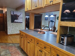 A kitchen with wooden cabinets, a granite countertop, and a built-in stove.