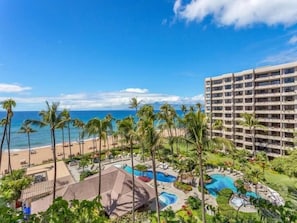 A resort with a pool area, palm trees, and a beach view. - Kaanapali Alii - 4 BR (2 condos), Sleeps 12 (Lahaina)