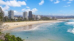 A coastal cityscape with a sandy beach, clear blue waters, and high-rise buildings. - Ocean Plaza 115 - Coolangatta Beachfront - Linen Provided - Min. 3 Night Stays (Coolangatta)