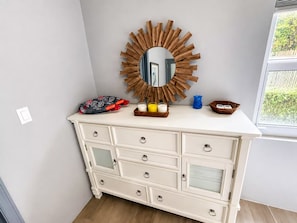 A white dresser with multiple drawers and a mirror with a wooden frame. - Relaxing Luxury Villa Private Beach Pool-Gym-AC-WiFi-King Bed-Sleeper Sofa (Turtle Bay)