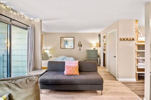 A modern living room with a sofa, a bed, a dresser, and a staircase. - Pet Friendly Mammoth Studio w/ self check in (Mammoth Lakes)