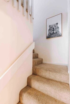 A carpeted staircase with a framed picture on the wall. - Charming Village Studio Loft (Mammoth Lakes)