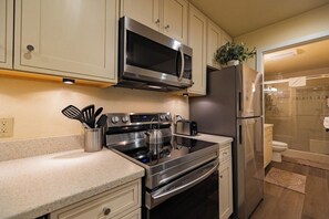 A modern kitchen with stainless steel appliances, including a microwave, stove, and refrigerator. - Pet Friendly 1BD 1BA Mammoth Retreat (Mammoth Lakes)