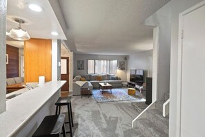 A modern living room with a sofa, coffee table, and TV. - Pet Friendly 2Bd 2.5 Ba Modern Vacation Home (Mammoth Lakes)