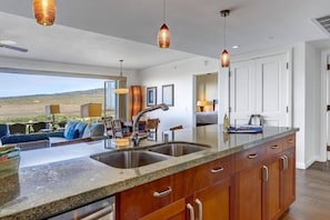 A modern kitchen with a large island, stainless steel appliances, and pendant lighting. - Honua Kai Resort - 4 BR (2 condos), Sleeps 8 (Lahaina)