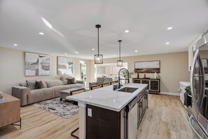A modern kitchen with a central island, built-in appliances, and pendant lighting. - Casa Anduro 5BR Pool & Spa Near San Diego (Chula Vista)