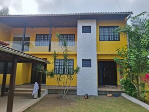 A two-story building with a yellow facade, a white central section, and a tiled roof. - New Listing (Vera Cruz)