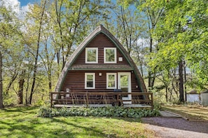 A two-story log cabin with a porch, surrounded by trees. - Gem of an A-Frame; 10 minutes from Downtown Dells (Wisconsin Dells)