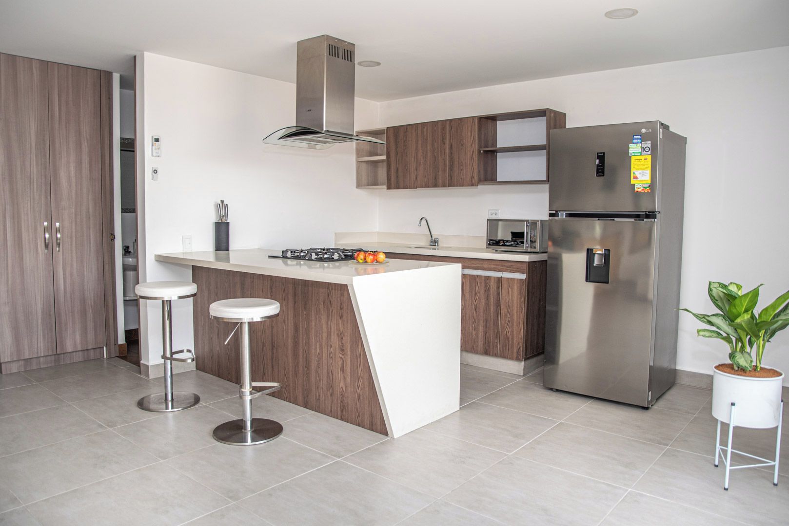 A modern kitchen with a central island, stainless steel appliances, and a minimalist design.