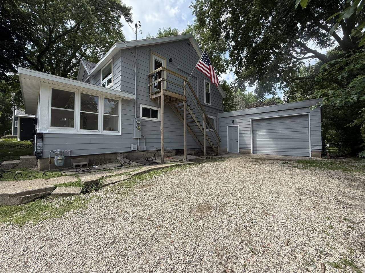 A two-story house with a front porch, a staircase, and a garage.