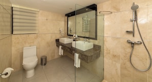 A modern bathroom with a toilet, sink, and shower. - 2BR Suite with Kitchen in All-Inclusive Resort, Half Block to Cofresi Beach (Puerto Plata)