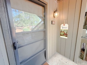 A door with a frosted glass panel, a mailbox with a tag, and a number '151' on the wall. - Pinehurst Poolside Retreat - Steps to Lake Pinehurst - 2 BR Condo (Pinehurst)