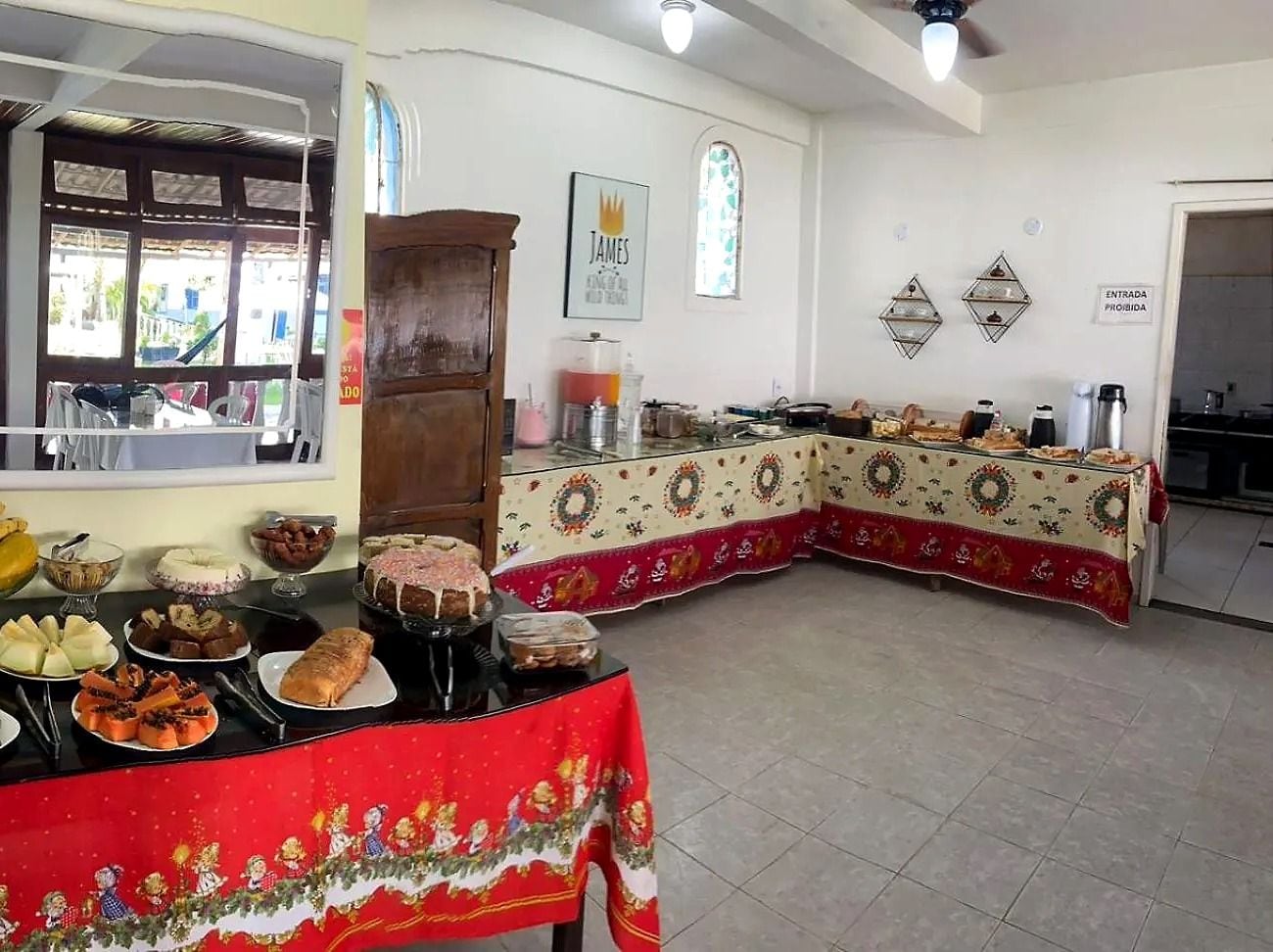 A dining area with a buffet setup, including various food items and a decorative tablecloth.