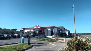 A casino with a prominent sign, a parking lot, and a no entry sign. - Le Riva - FREHEL - Vacation Rental (FREHEL)