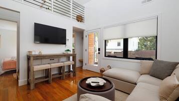 Open concept living space with a large sectional for max comfort and a smart tv