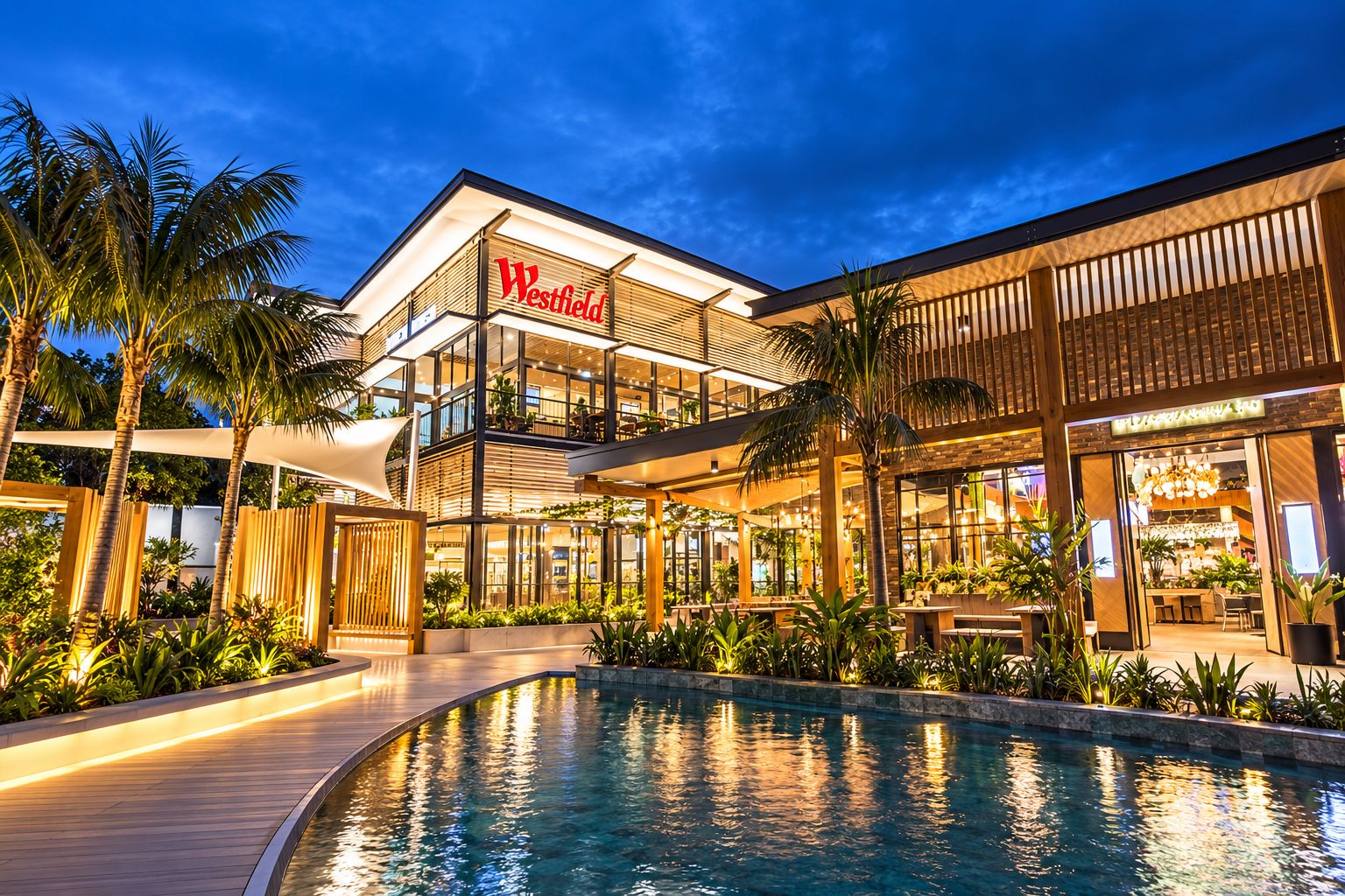 A Westfield shopping mall with a pool area, surrounded by palm trees and modern architecture.