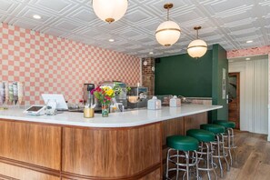 A bar area with a checkered wall, a wooden counter, and green bar stools. - Large Group Stay | Walk to St Augustine Downtown (St. Augustine)