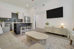 A modern kitchen with white cabinets, a built-in oven, and a stainless steel refrigerator. - Walk to Historic Downtown | 3BD/2BA | Private Yard (St. Augustine)