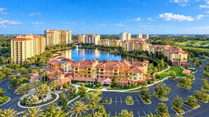 A hotel complex with multiple buildings, a central courtyard, and a lake. - Bonnet Creek Resort - Spacious 1 BR Presidential near Lake Buena Vista (Lake Buena Vista)