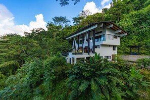 A modern two-story building surrounded by dense tropical foliage. - Beauty of Costa Rica by Pura Villas (Bahía Ballena)