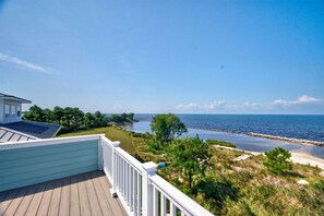 A deck with a view of a beach and ocean. - BayGlass Cove | Beachfront home in Bay Creek (Cape Charles)