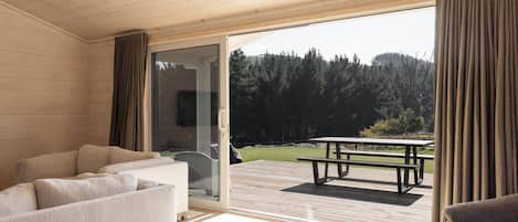 A modern interior with a sliding glass door leading to an outdoor patio area.