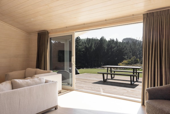 A modern interior with a sliding glass door leading to an outdoor patio area.