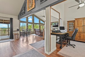 A spacious room with a large window, a desk with a computer, and a chair. - Quincy's Mountain Cabin Getaway with spectacular views and peaceful serenity! (Florissant)