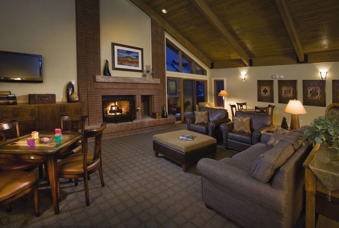 A cozy living room with a fireplace, comfortable seating, and a television.