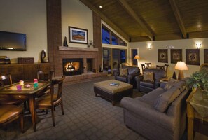 A cozy living room with a fireplace, comfortable seating, and a television. - Spacious & Comfortable 3 bedroom condo in the heart of ski country (Steamboat Springs)