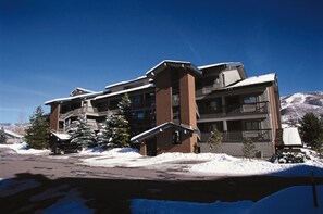A multi-story hotel with a ski lift visible in the background. - Spacious & Comfortable 3 bedroom condo in the heart of ski country (Steamboat Springs)
